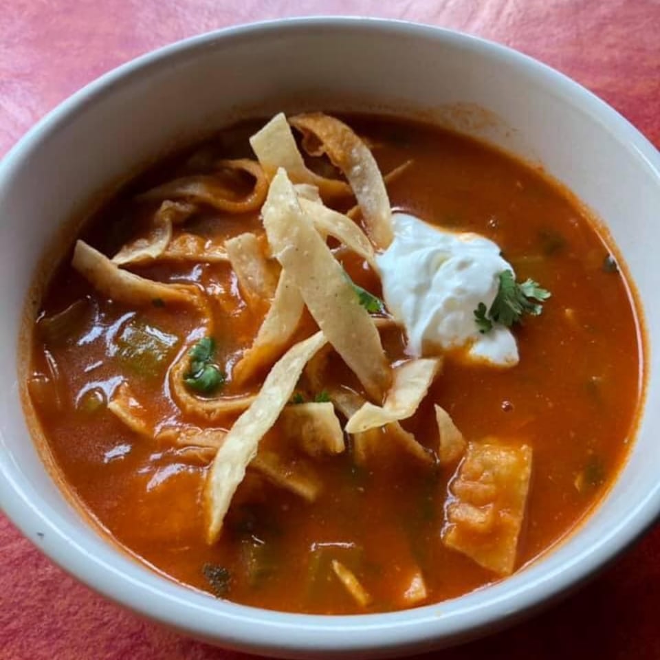 Maria's Mexican Restaurant's tortilla soup, garnished with tortilla strips, sour cream, and cilantro.
